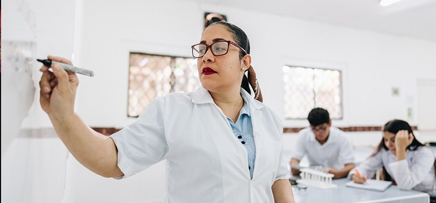 Woman at the white board teaching a class 