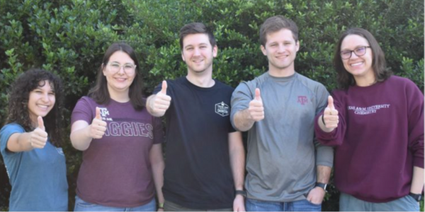 Graduate student organizers at Texas A&M give the camera a thumbs up