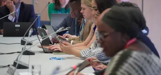 Meeting participants read over materials intently 