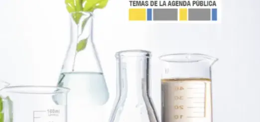 Temas de la agenda publica. Several beakers, with one that has a plant growing out of it