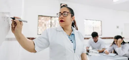 Woman at the white board teaching a class 