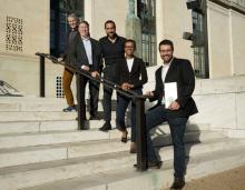 Award winners stand in front of the National Academy of Sciences