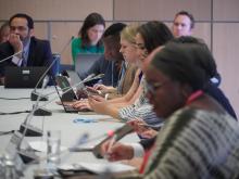 Meeting participants read over materials intently 