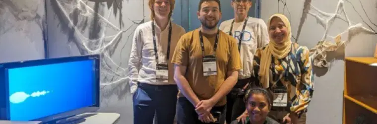 A group of students smiles after completing the Lab 217 escape room at the green chemistry and engineering conference