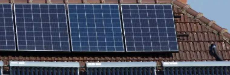 solar panels line the roof of an old house