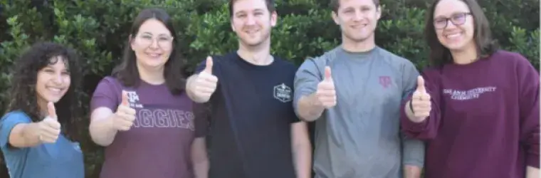 Graduate student organizers at Texas A&M give the camera a thumbs up
