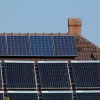 solar panels line the roof of an old house