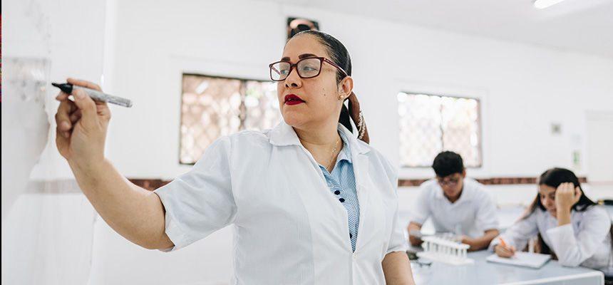 Woman at the white board teaching a class